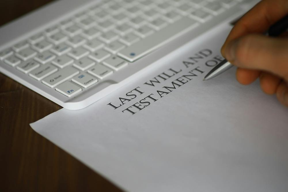 Person writing their will out on paper
